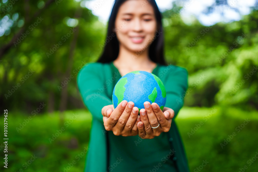 An Asian woman holds a globe in a green forest,symbolizing the importance of preserving nature.emphasizes balance between humans, natural resources,sustainable environmental development protect An Asian woman holds a globe in a green forest,symbolizing the importance of preserving nature.emphasizes balance between humans, natural resources,sustainable environmental development protect