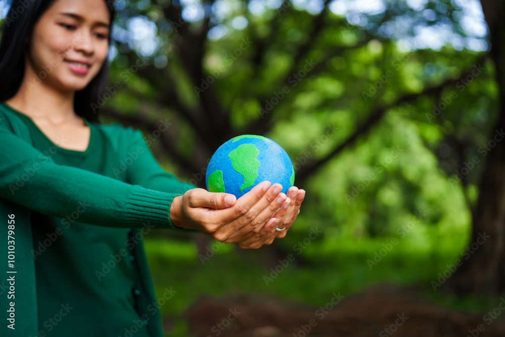 An Asian woman holds a globe in a green forest,symbolizing the importance of preserving nature.emphasizes balance between humans, natural resources,sustainable environmental development protect An Asian woman holds a globe in a green forest,symbolizing the importance of preserving nature.emphasizes balance between humans, natural resources,sustainable environmental development protect