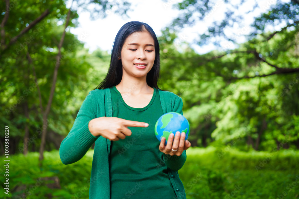 An Asian woman holds a globe in a green forest,symbolizing the importance of preserving nature.emphasizes balance between humans, natural resources,sustainable environmental development protect An Asian woman holds a globe in a green forest,symbolizing the importance of preserving nature.emphasizes balance between humans, natural resources,sustainable environmental development protect
