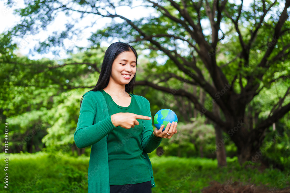 An Asian woman holds a globe in a green forest,symbolizing the importance of preserving nature.emphasizes balance between humans, natural resources,sustainable environmental development protect An Asian woman holds a globe in a green forest,symbolizing the importance of preserving nature.emphasizes balance between humans, natural resources,sustainable environmental development protect