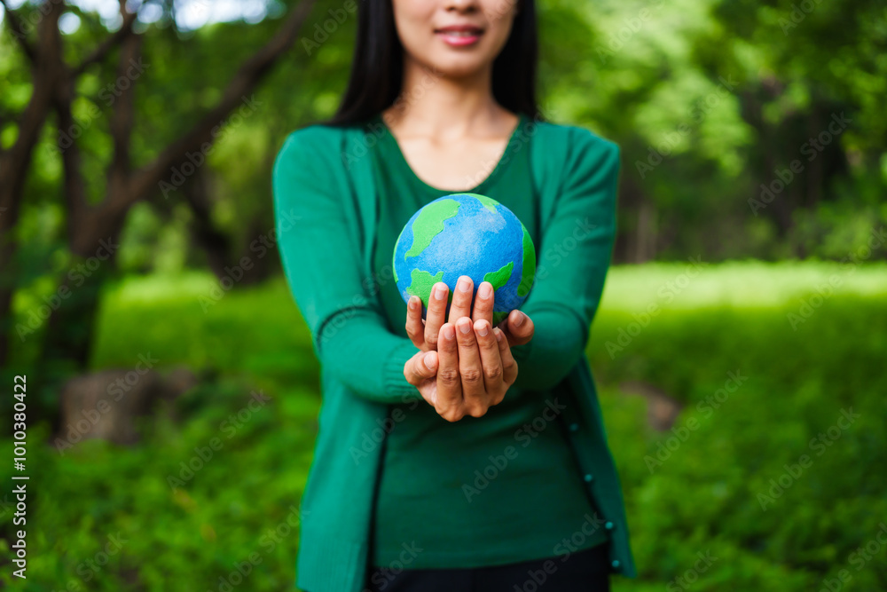 An Asian woman holds a globe in a green forest,symbolizing the importance of preserving nature.emphasizes balance between humans, natural resources,sustainable environmental development protect An Asian woman holds a globe in a green forest,symbolizing the importance of preserving nature.emphasizes balance between humans, natural resources,sustainable environmental development protect