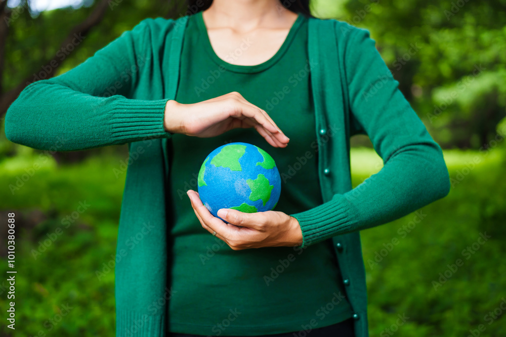 An Asian woman holds a globe in a green forest,symbolizing the importance of preserving nature.emphasizes balance between humans, natural resources,sustainable environmental development protect An Asian woman holds a globe in a green forest,symbolizing the importance of preserving nature.emphasizes balance between humans, natural resources,sustainable environmental development protect