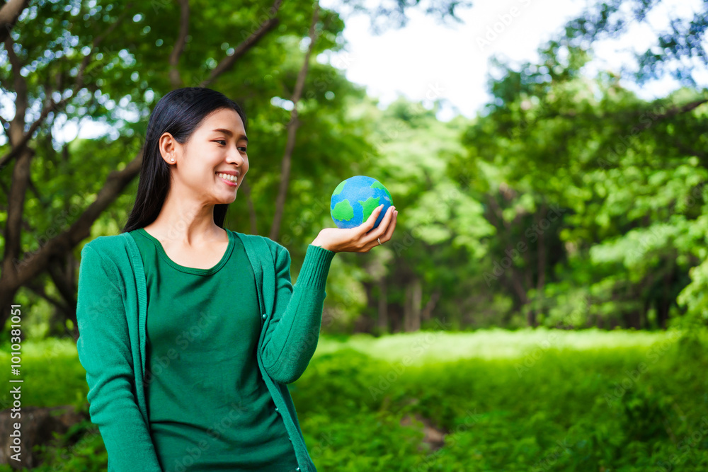 An Asian woman holds a globe in a green forest,symbolizing the importance of preserving nature.emphasizes balance between humans, natural resources,sustainable environmental development protect An Asian woman holds a globe in a green forest,symbolizing the importance of preserving nature.emphasizes balance between humans, natural resources,sustainable environmental development protect