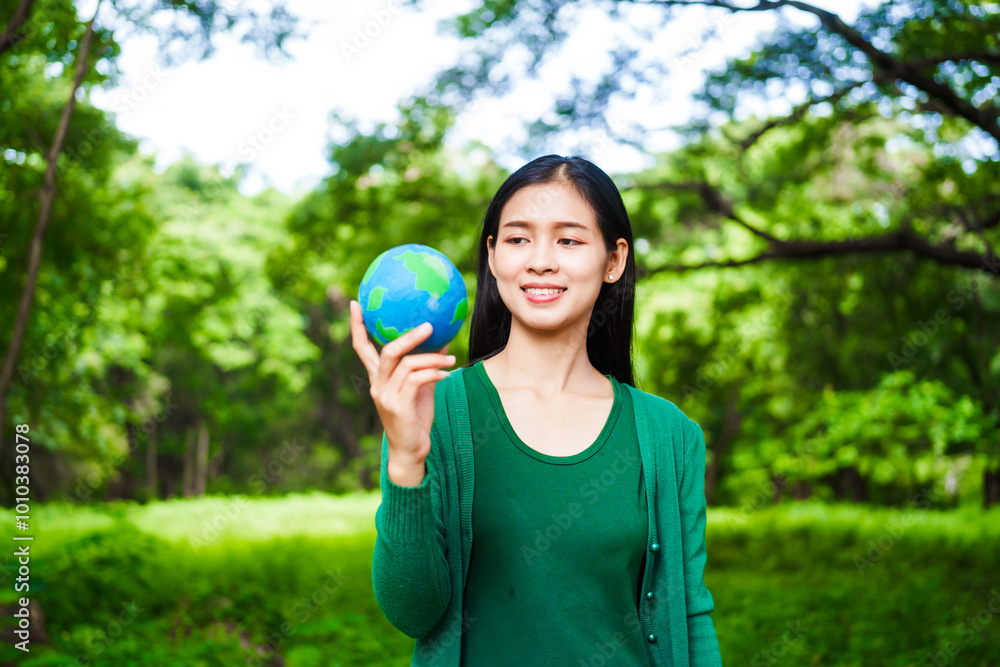 An Asian woman holds a globe in a green forest,symbolizing the importance of preserving nature.emphasizes balance between humans, natural resources,sustainable environmental development protect An Asian woman holds a globe in a green forest,symbolizing the importance of preserving nature.emphasizes balance between humans, natural resources,sustainable environmental development protect