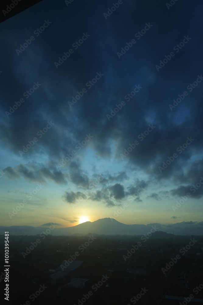Landscape background with sunrise over misty mountains. Dramatic sky, rolling hills and serene nature scene at twilight. Landscape background with sunrise over misty mountains. Dramatic sky, rolling hills and serene nature scene at twilight.