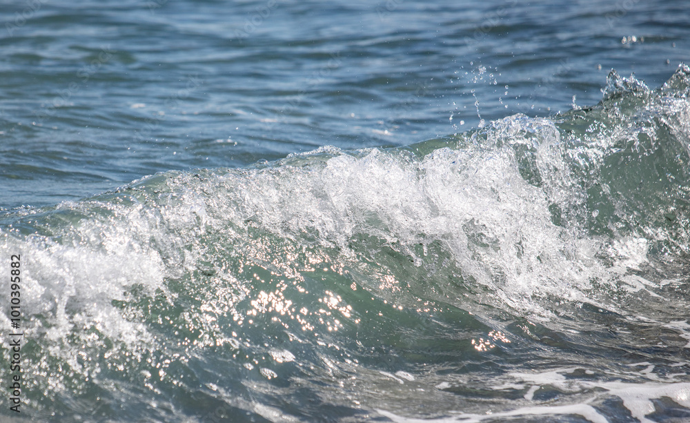 A sea wave breaks against the rocks, water splashes in the sky. Tidal wave. A sea wave breaks against the rocks, water splashes in the sky. Tidal wave.