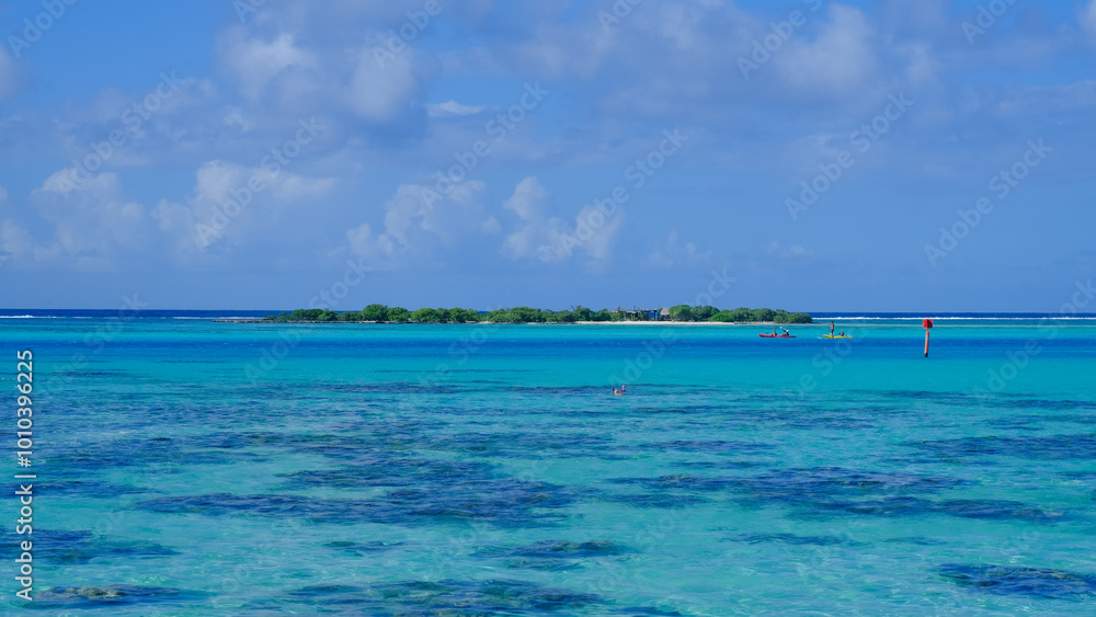 Scenic view of Coco Island in lagoon of beautiful turquoise ocean water and coral reef on Mo'orea, Tahiti in French Polynesia, South Pacific Scenic view of Coco Island in lagoon of beautiful turquoise ocean water and coral reef on Mo'orea, Tahiti in French Polynesia, South Pacific