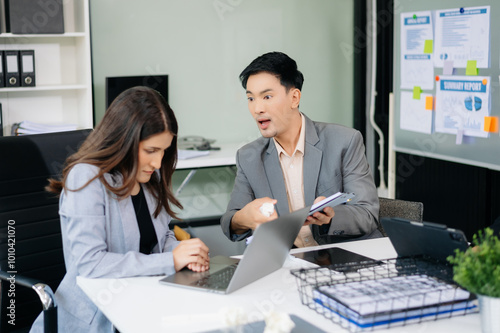 Furious Asian businesspeople arguing strongly after making a mistake at work in office