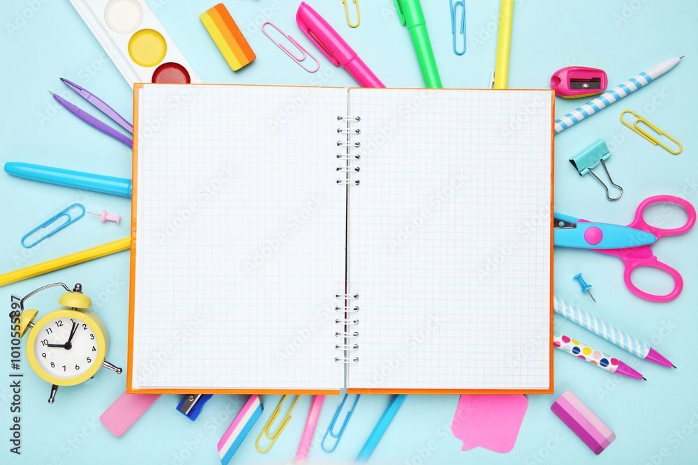 School supplies with blank notepad for text on blue background` School supplies with blank notepad for text on blue background`
