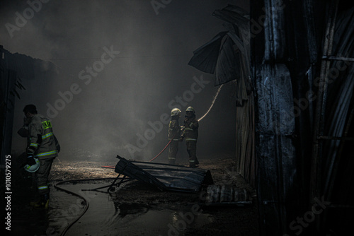 Firefighters extinguish a fire at a warehouse. photo