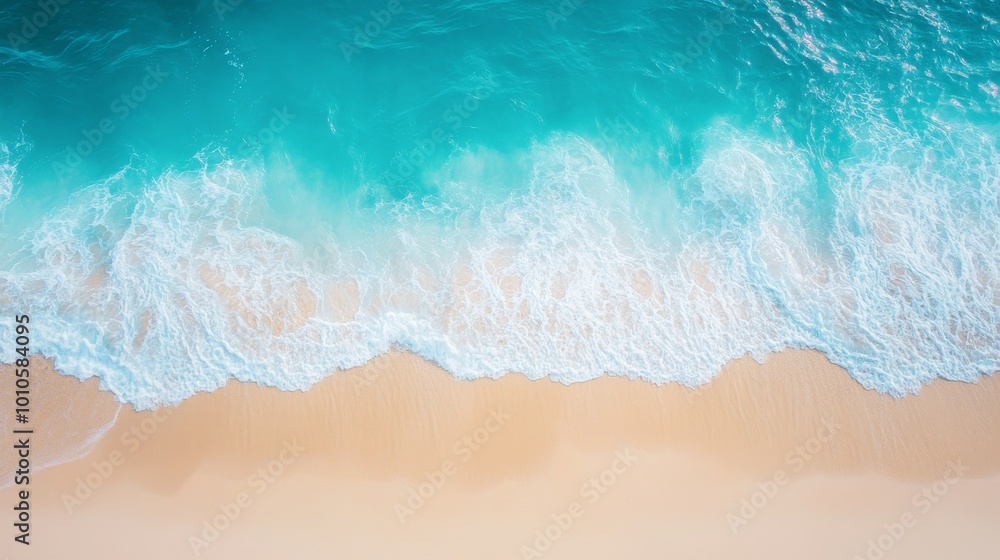 An aerial view of a sandy beach and turquoise ocean waves crashing on the shore. An aerial view of a sandy beach and turquoise ocean waves crashing on the shore.