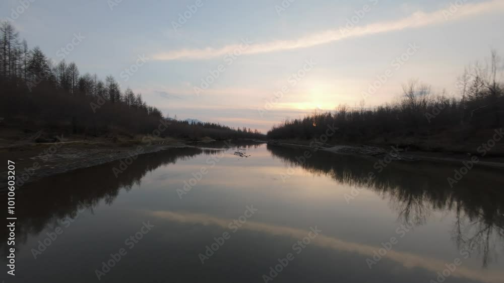 Experience the tranquility of a river embraced by trees as the sun sets, casting warm hues over the landscape. Nature unfolds in a harmonious blend of water and light, inviting calm. Experience the tranquility of a river embraced by trees as the sun sets, casting warm hues over the landscape. Nature unfolds in a harmonious blend of water and light, inviting calm.