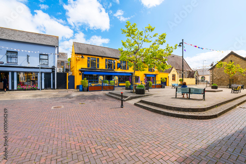 Canvastavla Market Quay, a small market square full of brightly painted cafes and shops near the port and marina of the seaside village of Kinsale, Ireland