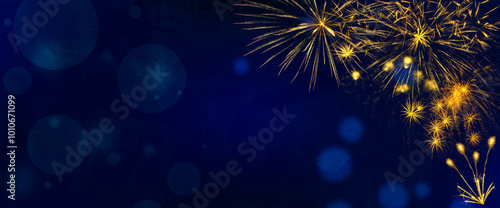 Golden fireworks burst on blue texture background with copy space