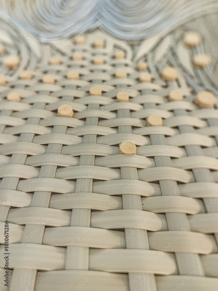 Fototapeta premium A meticulously woven pattern, likely made from light-colored materials