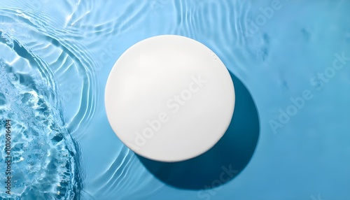 Round white podium for cosmetics on the water surface. Top view.