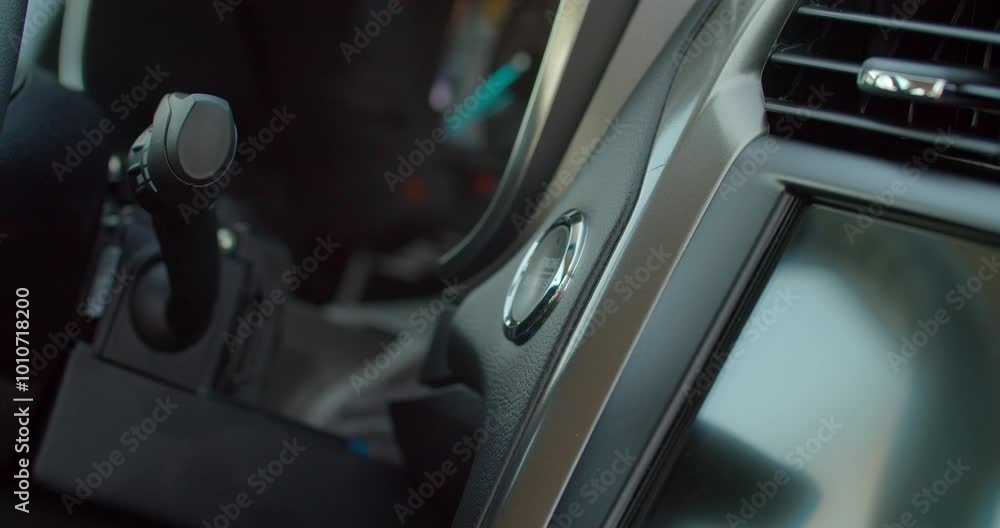 Starting car engine. Track in to the button. Finger press the button to start the car engine. Starting car engine. Track in to the button. Finger press the button to start the car engine.