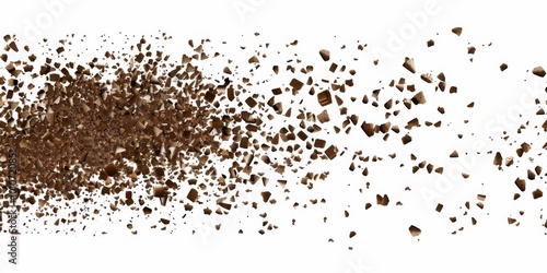 A cascade of chocolate shades in a grainy texture flows gracefully against a clean white backdrop, creating a visually enticing display of delicately scattered brown particles.