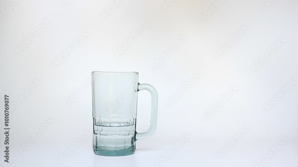 Someone pouring some water into a glass, drink the water, and put the glass back. Someone pouring some water into a glass, drink the water, and put the glass back.