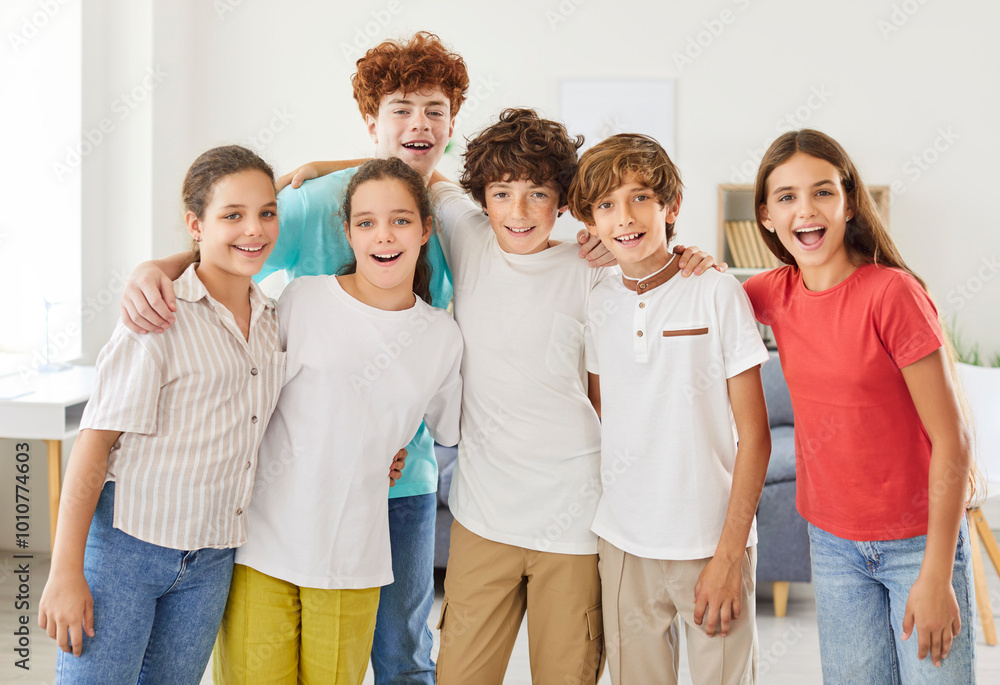 Portrait of a group of happy teenage schoolchildren in a classroom. Diverse students standing together. Friendship, teamwork, and positive social interactions in educational environment. Portrait of a group of happy teenage schoolchildren in a classroom. Diverse students standing together. Friendship, teamwork, and positive social interactions in educational environment.