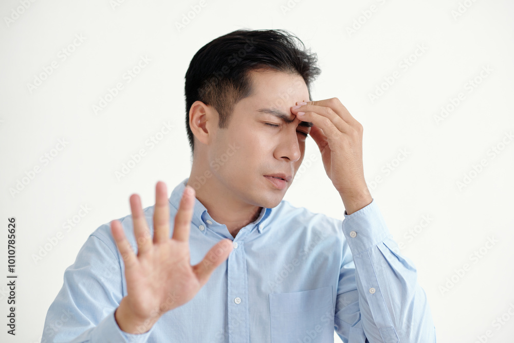Man having headache above his problems standing against white background Man having headache above his problems standing against white background