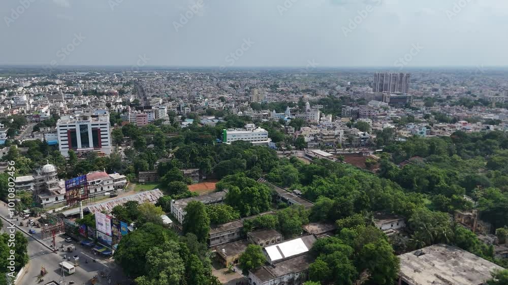 Captivating drone shot of Vijayawada city, where the busy city streets converge towards a serene hill in the background. Captivating drone shot of Vijayawada city, where the busy city streets converge towards a serene hill in the background.
