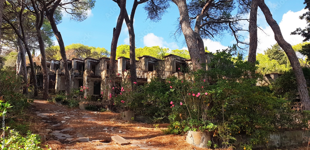 Old abandoned hotel in the form of villas on the island. Panorama. Old abandoned hotel in the form of villas on the island. Panorama.