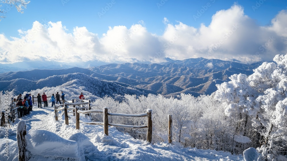 Φωτογραφία A winter scene atop Deogyusan Mountain, with tourists gazing at the snow-capped peaks and a frozen landscape stretching across Deogyusan National Park, near Muju, South Korea