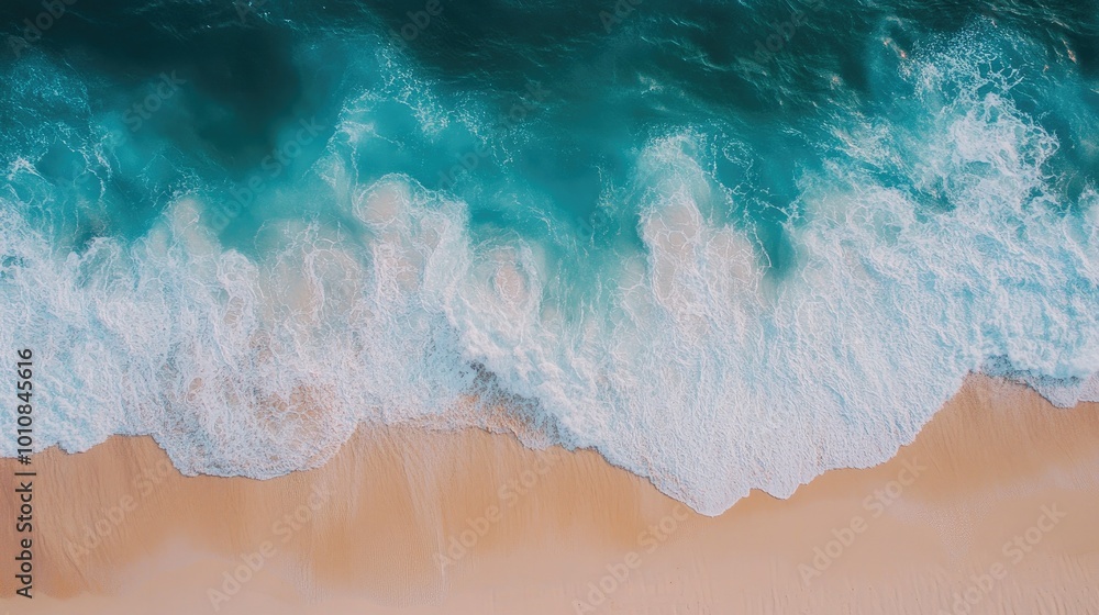 Aerial top-down view of blue ocean waves meeting a sandy beach in Vietnam, creating a serene and picturesque natural backdrop for summer. Aerial top-down view of blue ocean waves meeting a sandy beach in Vietnam, creating a serene and picturesque natural backdrop for summer.