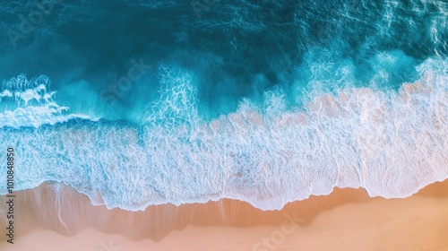 Beautiful ocean waves on a Vietnam beach, seen from above in an aerial view, with the blue water gently meeting the soft, sandy shore.