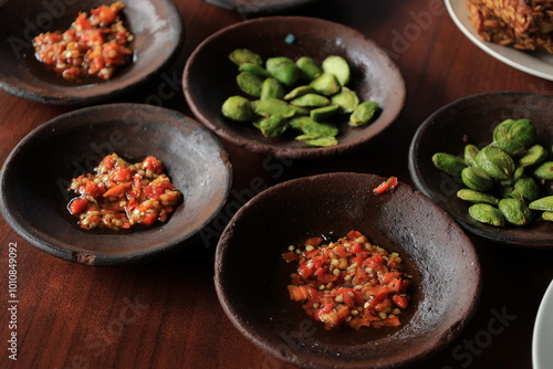 Lalapan or fresh raw vegetables basket with Pete (petai), chili sauce or sambal photo