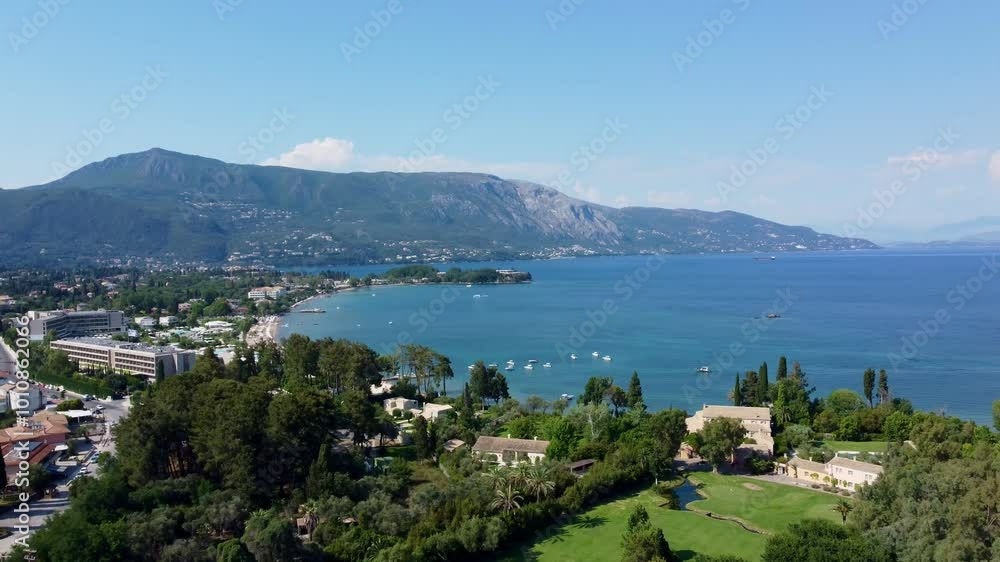 Dolly in drone aerial of luxury resorts on Dassia beach and coast, Corfu Island, Greece Dolly in drone aerial of luxury resorts on Dassia beach and coast, Corfu Island, Greece