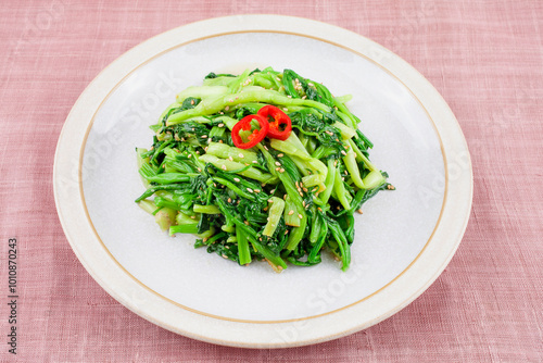 Korean food Minali-namul(seasoned water parsley) in a dish with cloth background