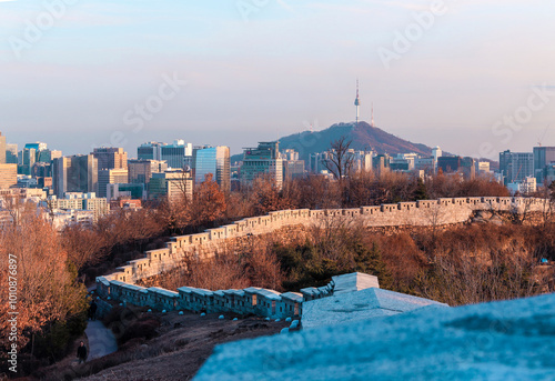 Changsin-dong, Jongno-gu, Seoul, Korea - January 22, 2020: Hanyangdoseong(Fortress Wall of Seoul ) with the background of N Seoul Tower and high-rise buildings photo