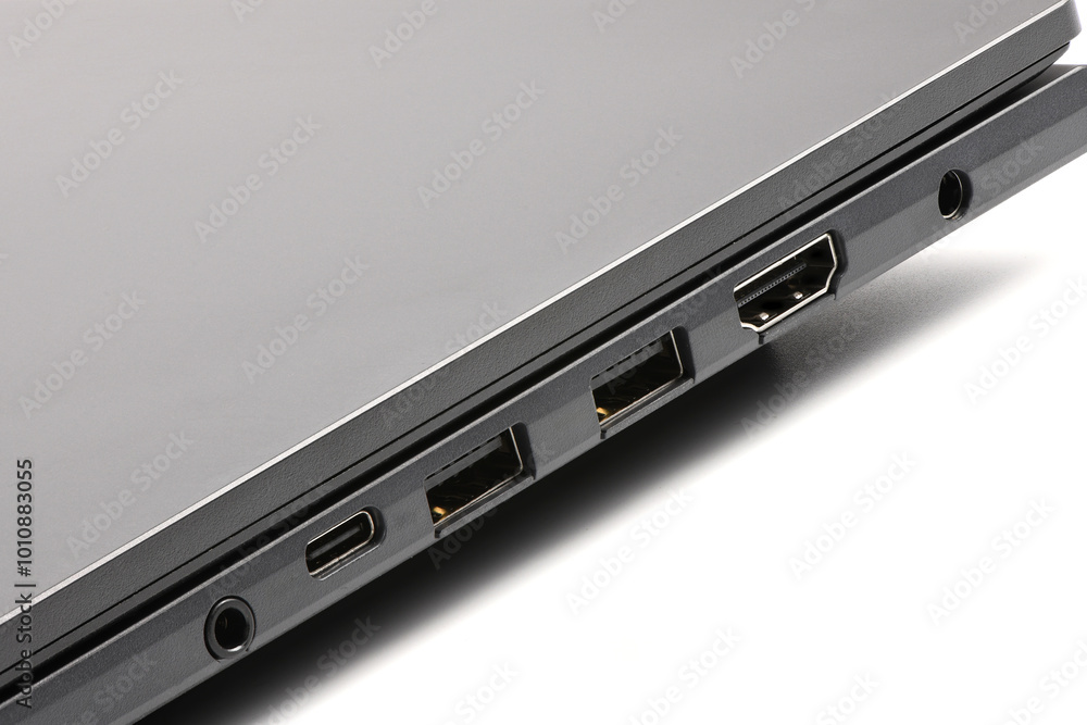Detailed side view of modern laptop with Power ports, HDMI, USB and audio ports. Detailed side view of modern laptop with Power ports, HDMI, USB and audio ports.