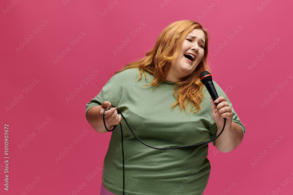 Joyful, plus-size woman in green shirt sings passionately into a microphone Joyful, plus-size woman in green shirt sings passionately into a microphone