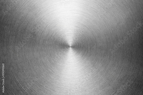 Stainless steel or aluminium circular brushed shiny metal texture. Abstract metallic background. Circle shape.
