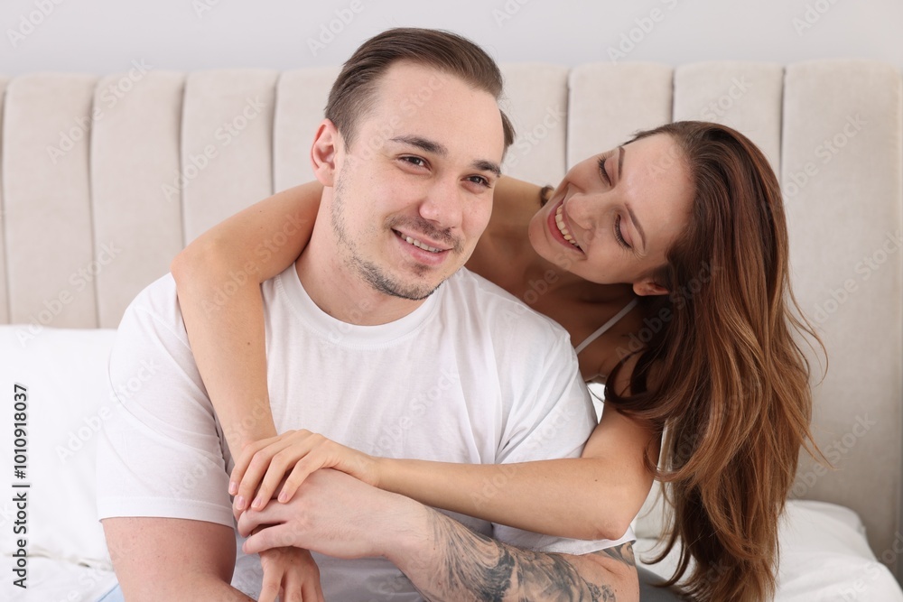 Happy couple spending time together on bed at home Happy couple spending time together on bed at home