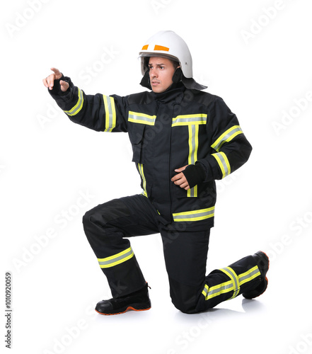 Full length portrait of firefighter in uniform and helmet on white background