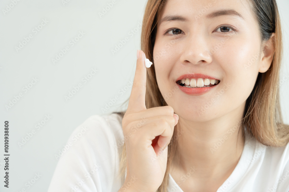 Beautiful Asian woman smile use cream for good skin. face of a healthy woman apply cream and makeup. Advertisement for skin cream, anti-wrinkle, baby face, whitening, moisturizer, tighten pores serum Beautiful Asian woman smile use cream for good skin. face of a healthy woman apply cream and makeup. Advertisement for skin cream, anti-wrinkle, baby face, whitening, moisturizer, tighten pores serum