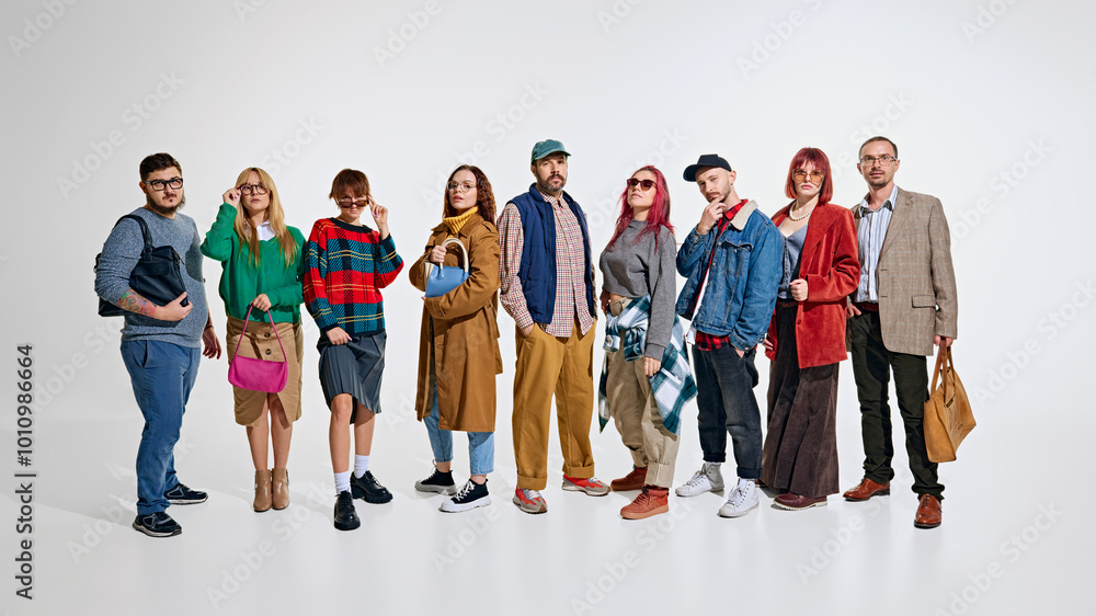 Obraz premium Group of people, men and women wearing stylish autumn outfits, waiting for seasonal sales. Ready to grab the best discounts. Concept of Black Friday, Cyber Monday, shopping