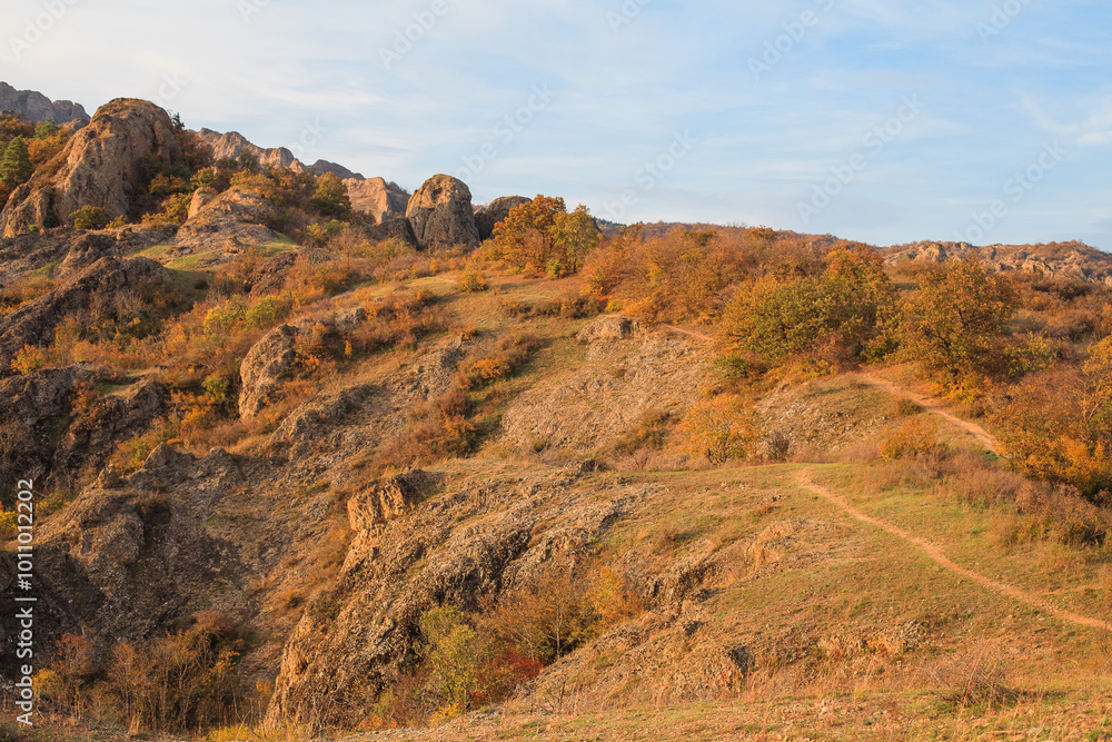 a panoramic view of autumn landscape with mountain hills surrounded by trees with yellow and red foliage at birtvisi canyon in georgia at a sunset light a panoramic view of autumn landscape with mountain hills surrounded by trees with yellow and red foliage at birtvisi canyon in georgia at a sunset light