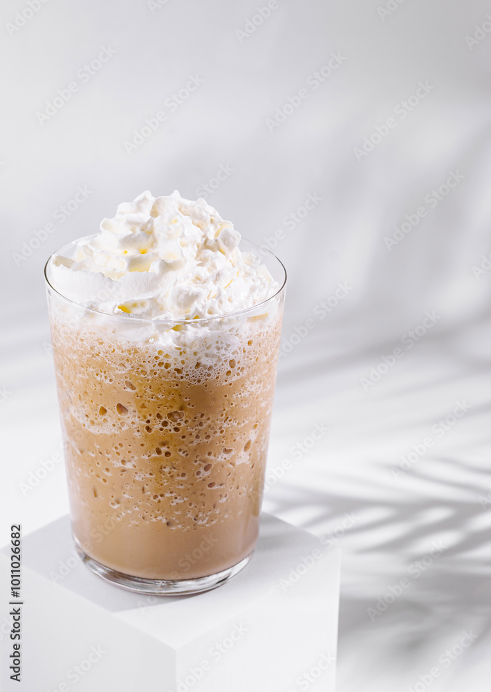 Iced coffee frappe topped with whipped cream on white background Iced coffee frappe topped with whipped cream on white background