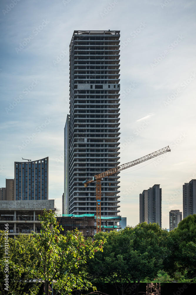 Fototapeta premium Modern Skyscraper Under Construction with Urban Landscape