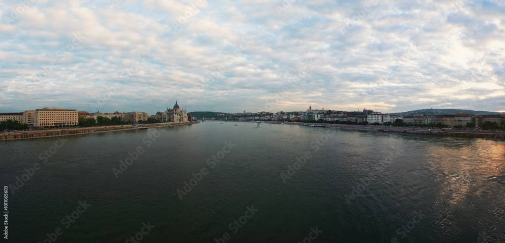 Fototapeta premium Sunset clouds over Danube river in Budapest, Hungary parliament building visible on left side