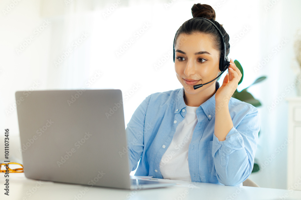 Well dressed gorgeous successful brunette caucasian woman with wireless headset, working in customer support service or helpline, female call center agent, sitting at her work desk with laptop Well dressed gorgeous successful brunette caucasian woman with wireless headset, working in customer support service or helpline, female call center agent, sitting at her work desk with laptop
