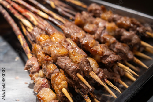 Delicious Meat Skewers Grilling Over Charcoal Barbecue photo