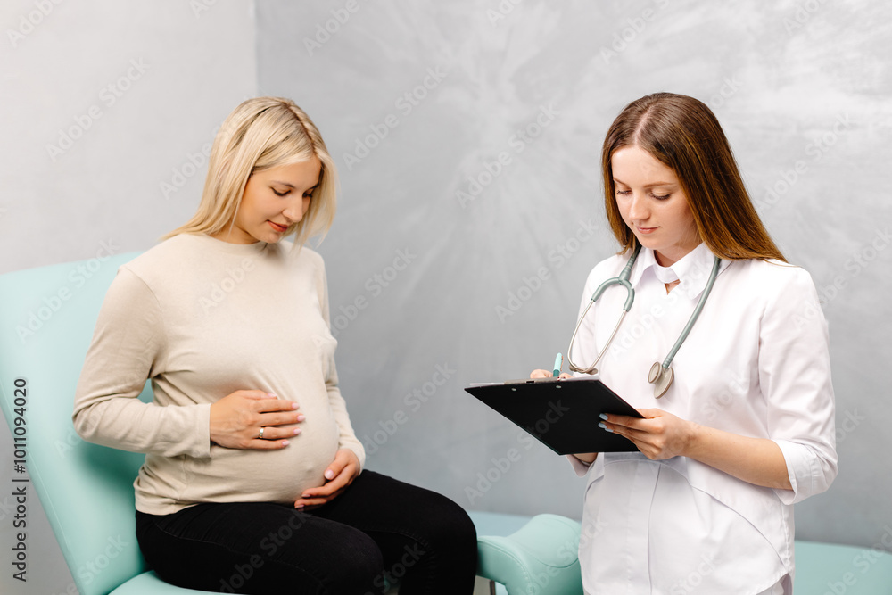 Gynecologist talking with a young female patient during a medical ...