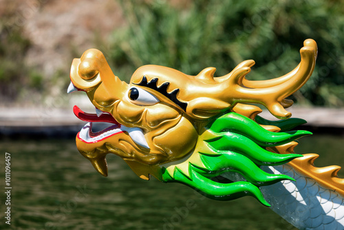 Fototapeta Golden dragon head figurehead adorning traditional wooden boat