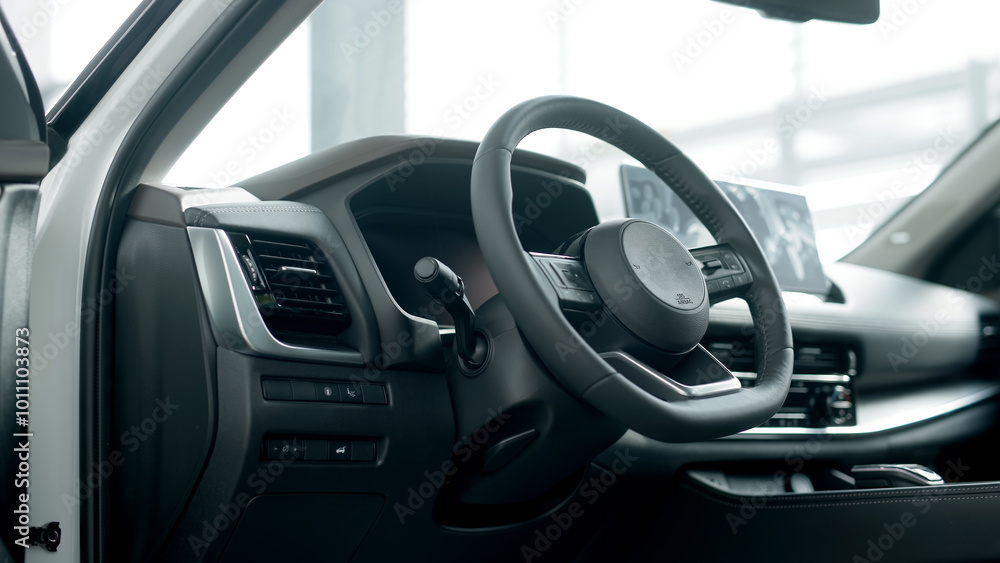 A close-up of a modern car's steering wheel showcases its sleek design and advanced features. This detailed view emphasizes the craftsmanship and innovation that enhance the driving experience. A close-up of a modern car's steering wheel showcases its sleek design and advanced features. This detailed view emphasizes the craftsmanship and innovation that enhance the driving experience.